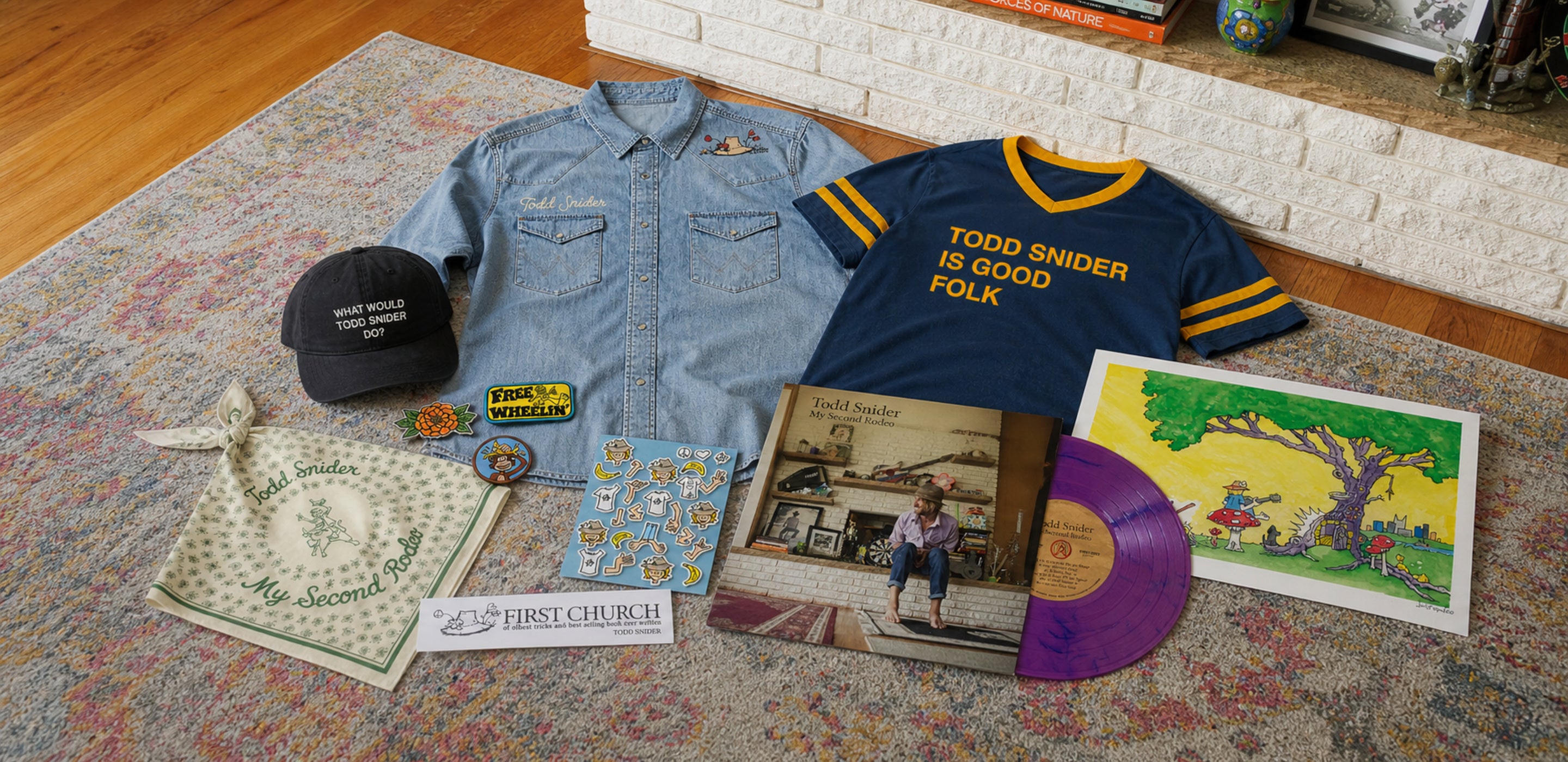 My Second Rodeo bundle merchandise laid out - denim western shirt, Good Folk jersey, hat, bandana, patches, magnets, signed print and vinyl
